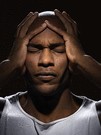 man holding head in pain