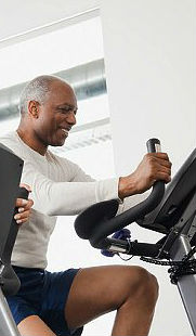older african american man exercising on a stationary bike