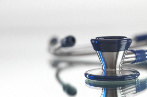 A stethoscope sitting on a glass background