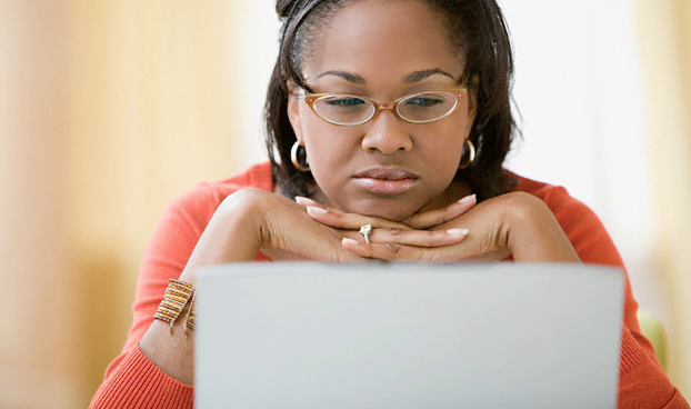 A woman reading on her laptop
