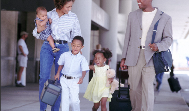 A family walking outside to an airport