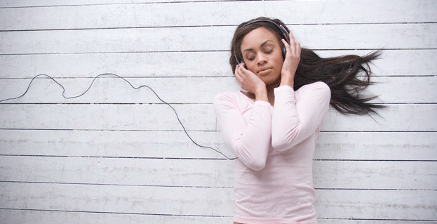 A woman listening to music on the floor