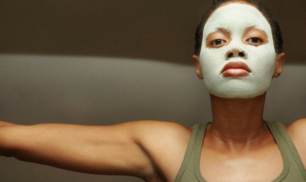 A woman wearing a mud face mask
