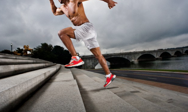 An athlete running up a flight of stairs
