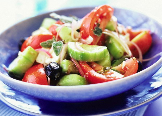 Greek salad in a blue bowl