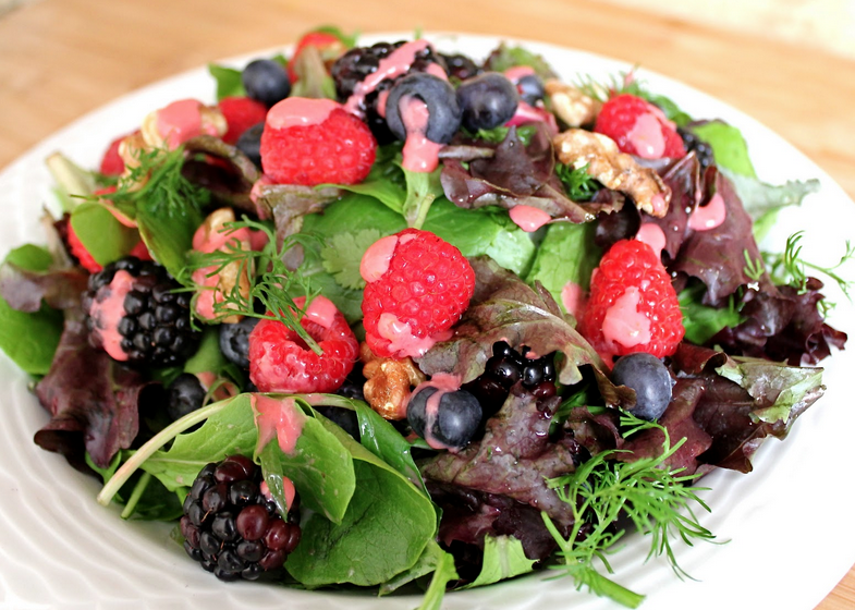 A white bowl filled with honey berry nut salad