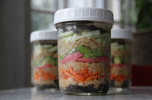 Mason jars filled with avocado crab sushi