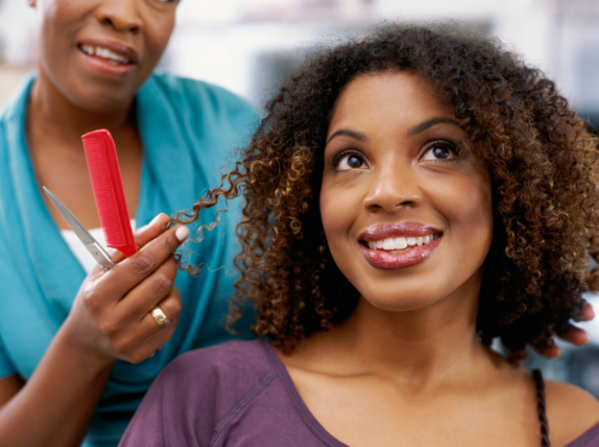 A woman having her hair done by a stylist