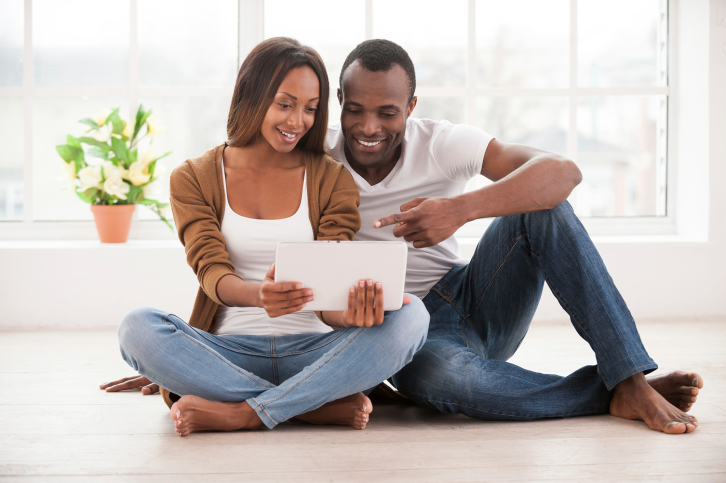 black couple with tablet