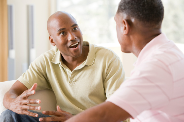 Two men in living room talking
