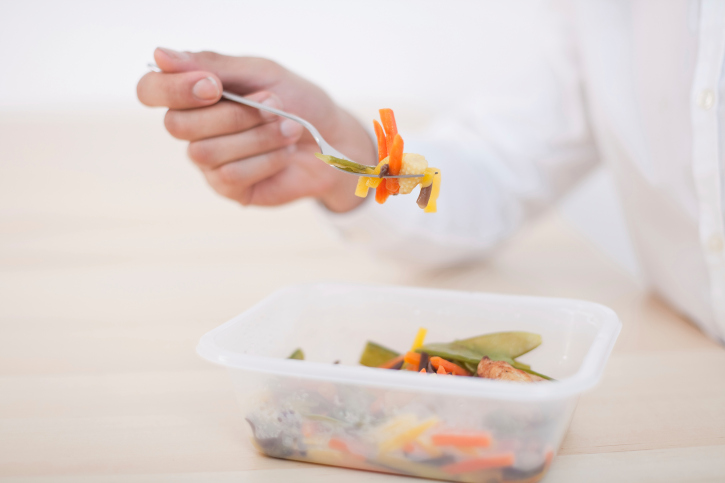 man eating microwave dinner