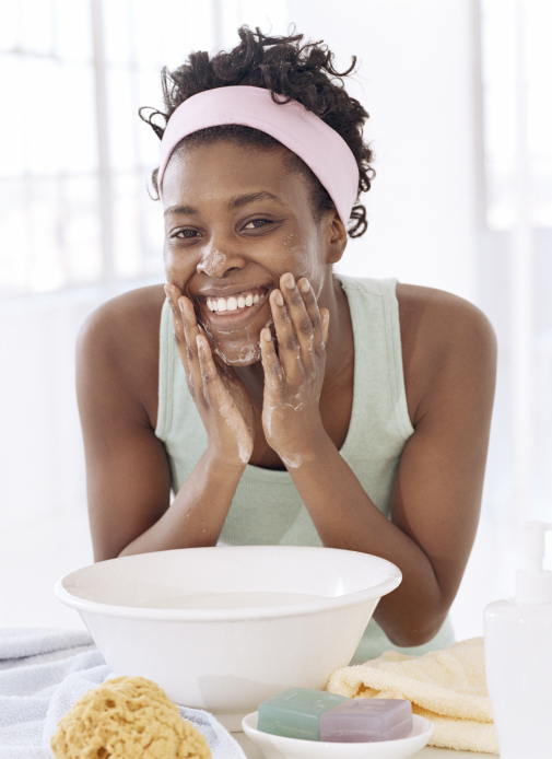 young woman washing face by face bowl