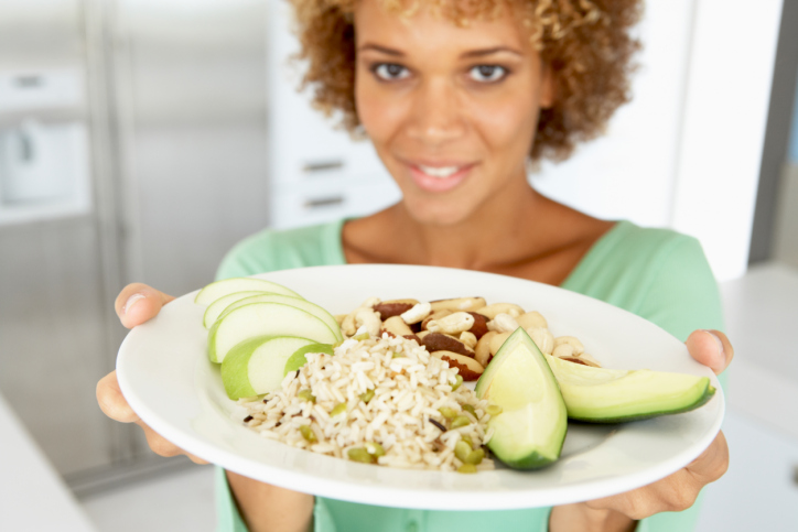 adult woman holding plate of food