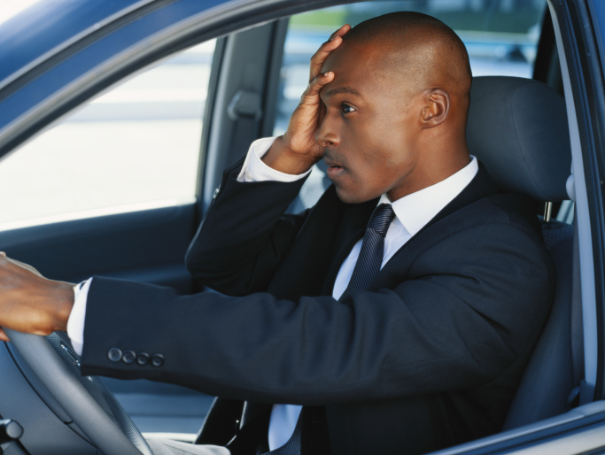 man stressed in car