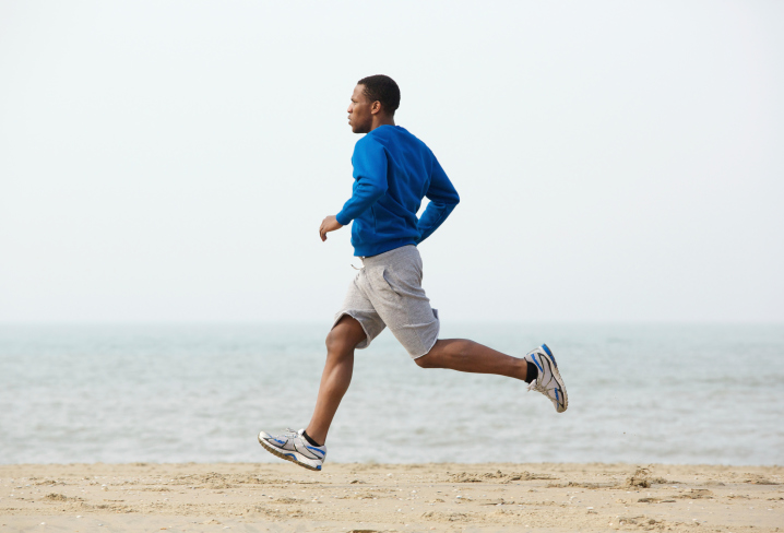 African American Black man running beach