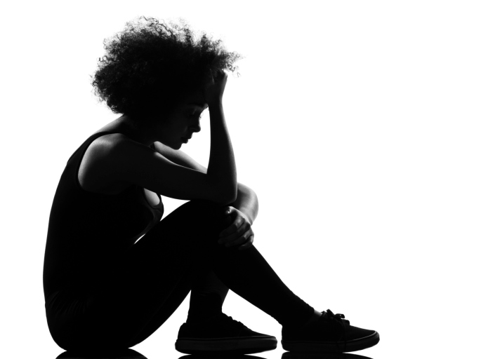 silhouette of woman sitting on ground