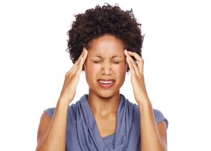 woman with headache, holding temples