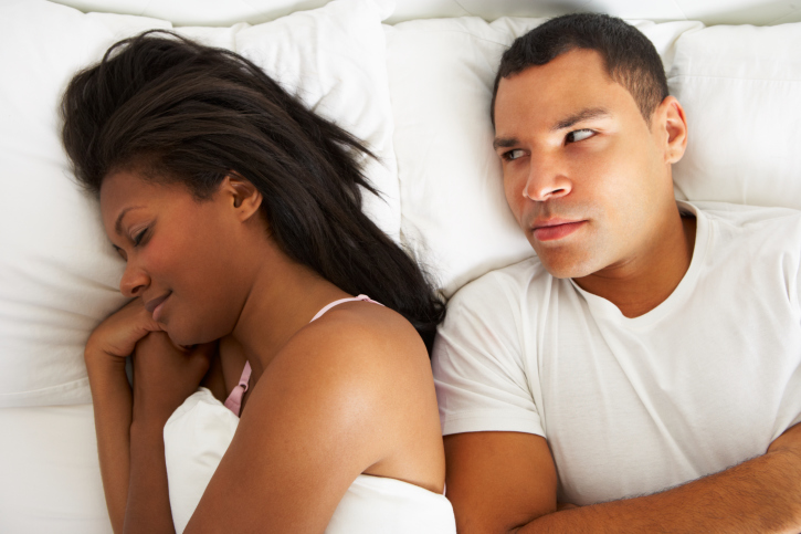 couple in bed with relationship difficulties