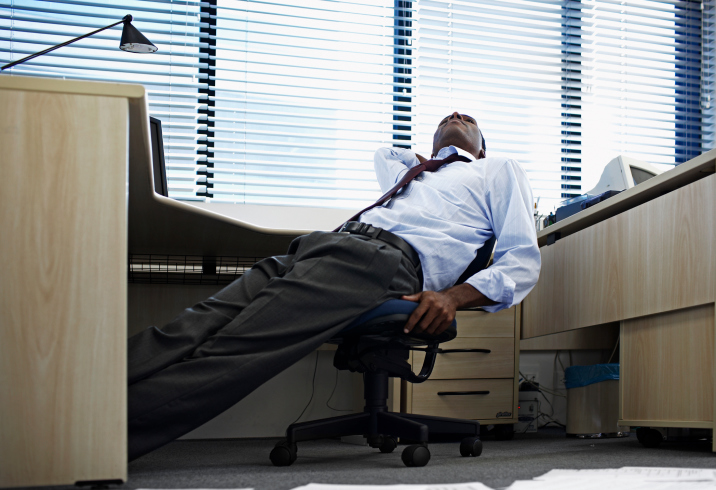 African American Black man bored tired at work office