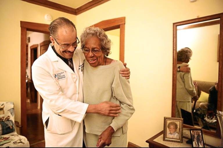doctor walking with older woman