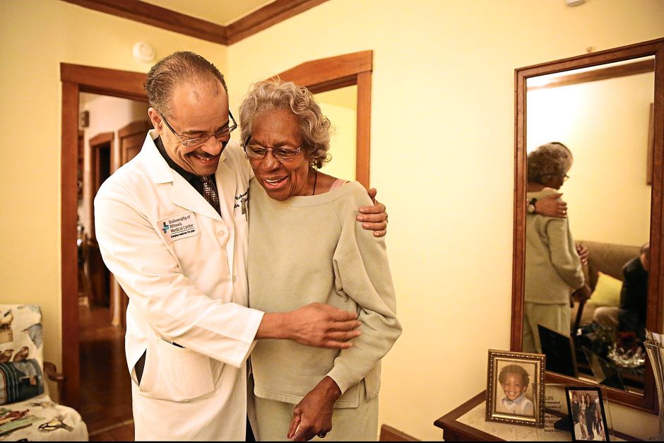 doctor walking with older woman