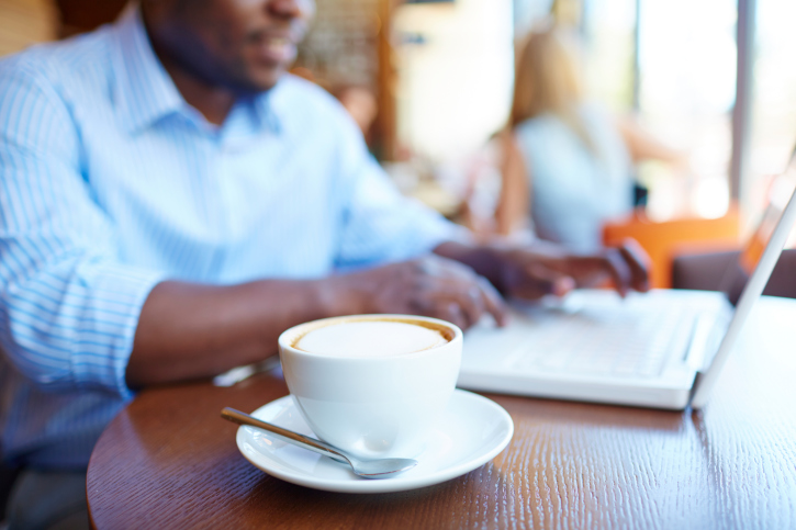 african american man sitting with a cup of coffee on the counter