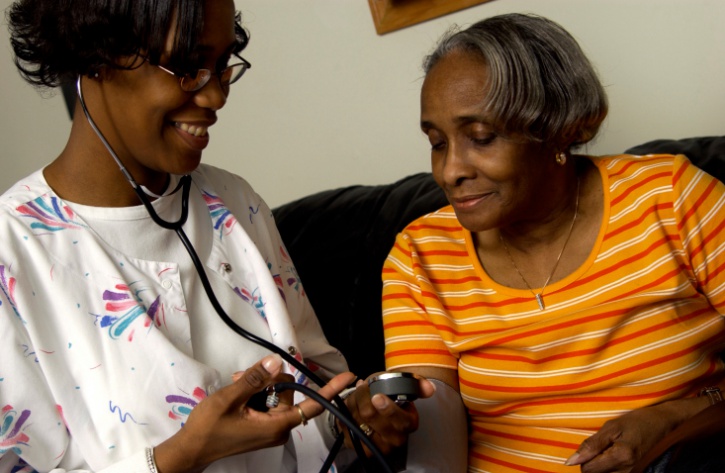 Nurse checking patient's blood pressure