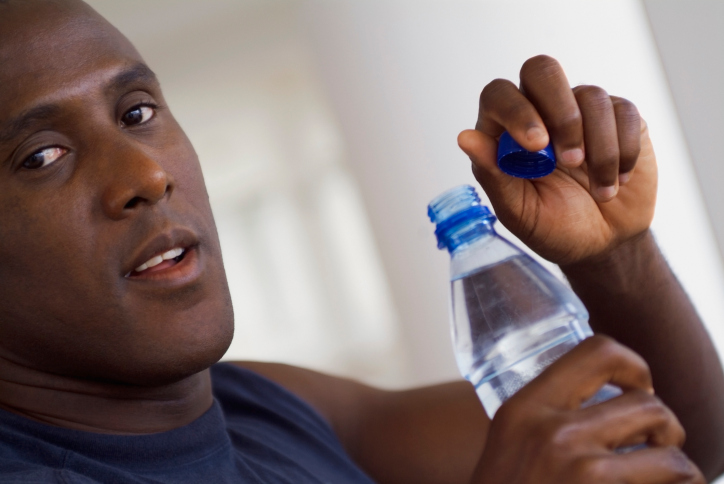man drinking from water bottle
