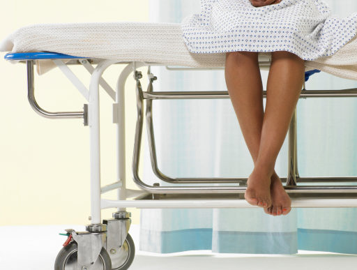 woman hospital patient sitting upright on stretcher