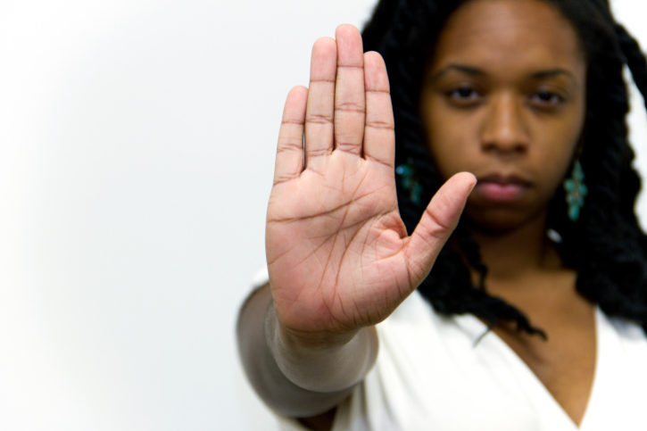 African American woman hand in stop sign