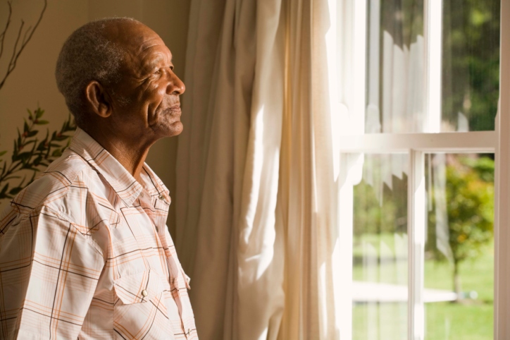 older man looking out of window