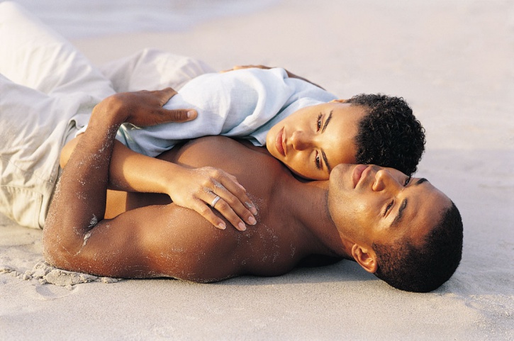 couple laying on beach serious
