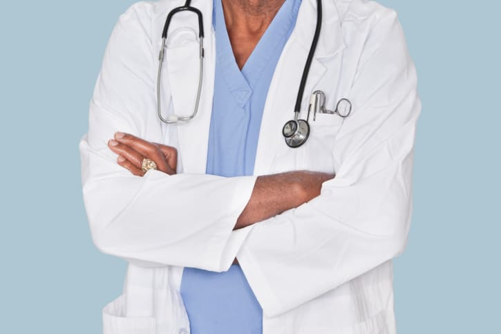 doctor with arms folded around chest