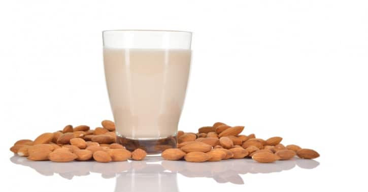 glass almond milk with almonds
