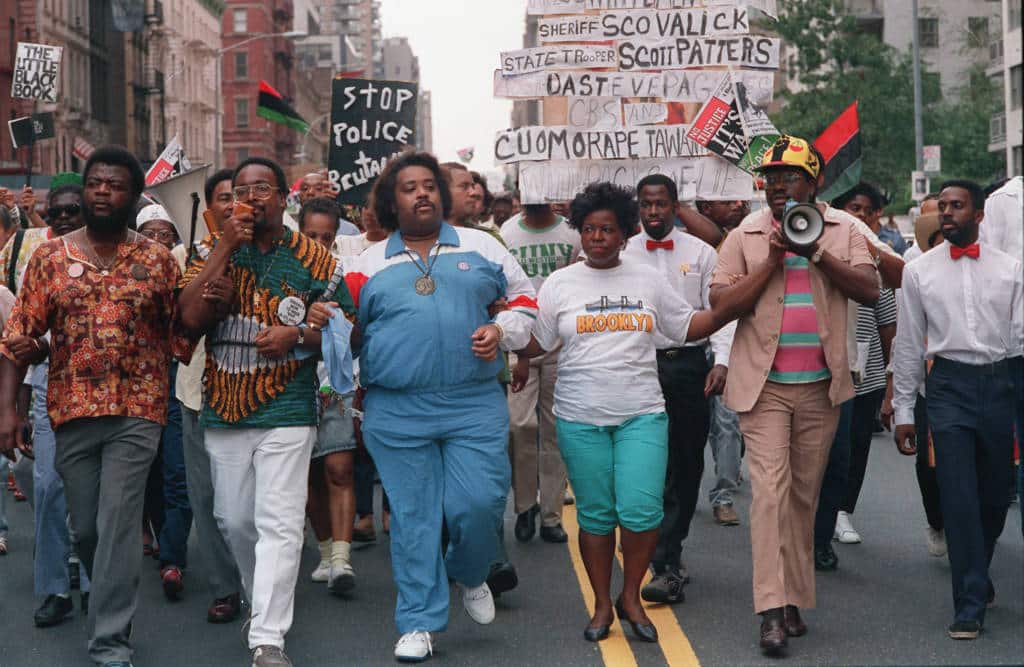 Advisers to Tawana Brawley, Attorney C. Vernon Mason, second from left, the Rev. Al Sharpton, center, and attorney Alton Maddox, lead a march toward Mayor Ed Koch's residence at Gracie Mansion in New York City on Sunday, Aug. 28, 1988. The others in the front are unidentified. (AP Photo/Charles Wenzelberg)