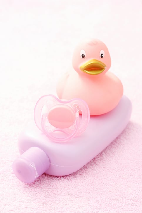 baby lotion, pacifier and plastic ducky
