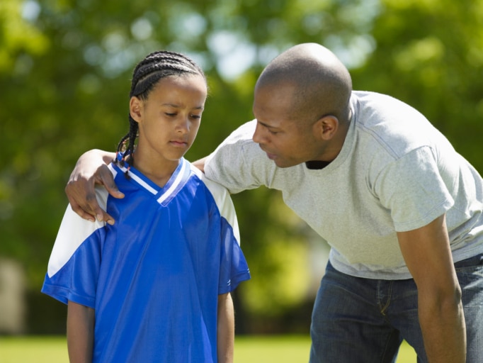 father and son talking while in the park