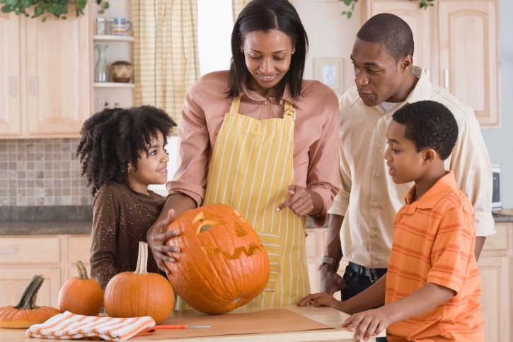 Family carving Halloween pumpkin