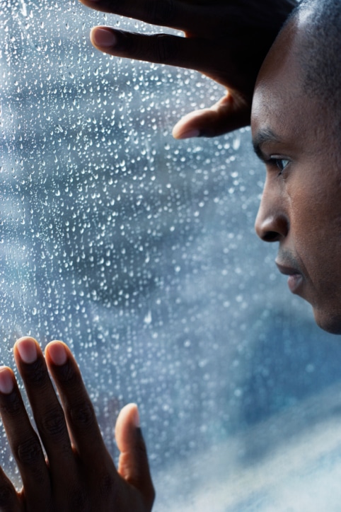 man looking out of window