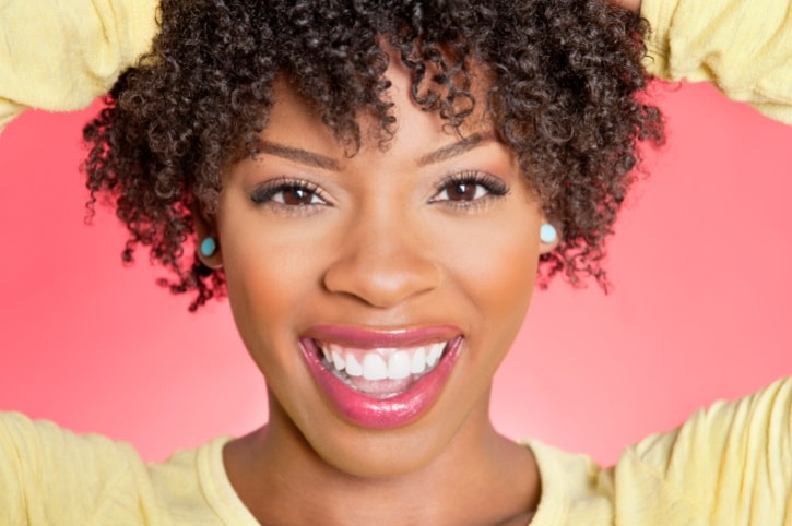 African American woman smiling with curly short hair