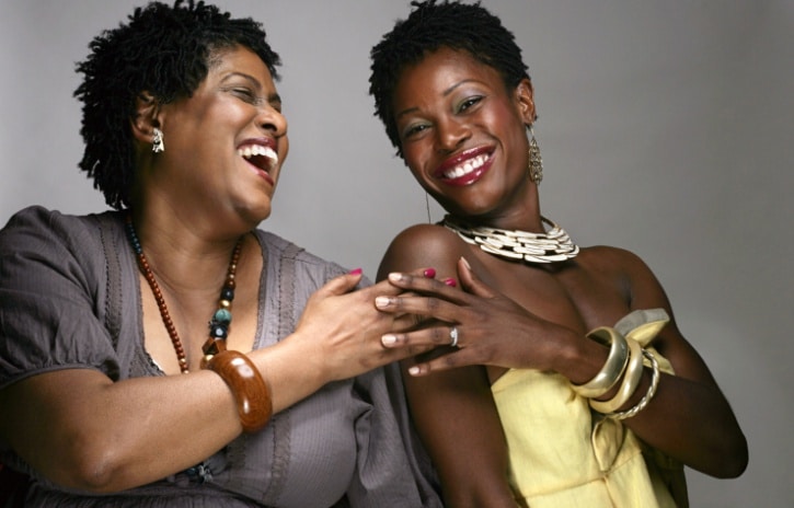 two African American women friends laughing smiling