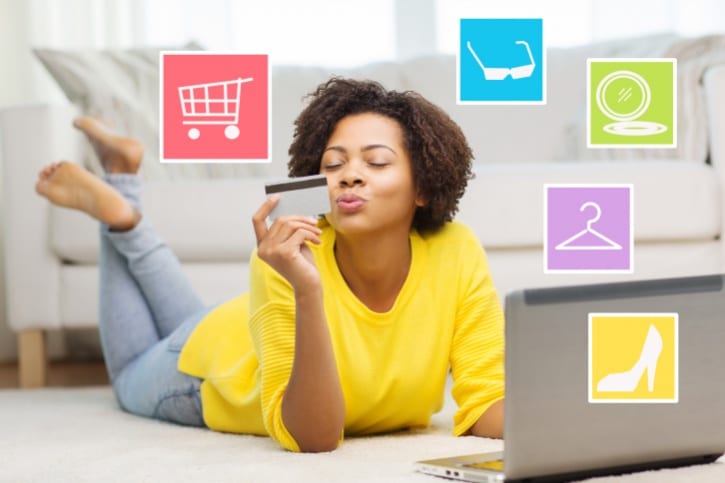 African American woman shopping on laptop with credit card