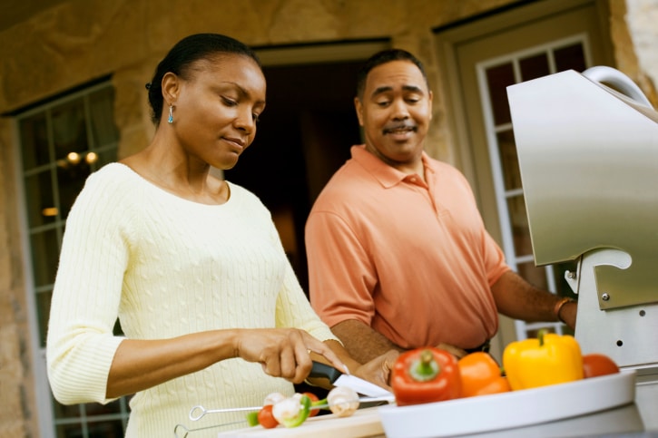 African American couple cooking together
