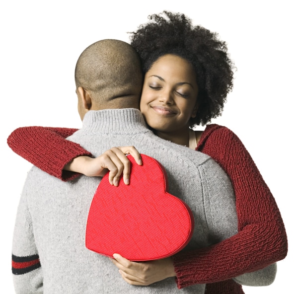 Young African American couple hugging with Valentine heart