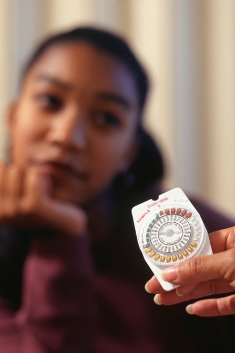 African American woman with birth control pills