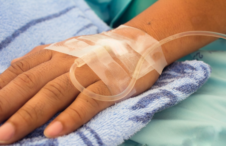 closeup shot of a patient's hand with saline intravenous (iv)