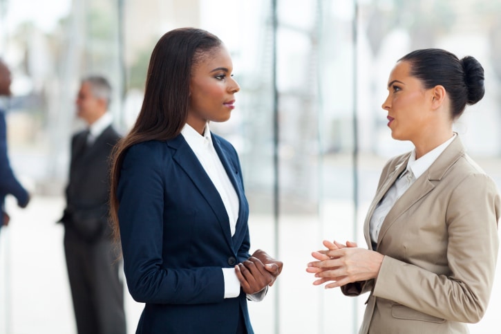 two women in office talking