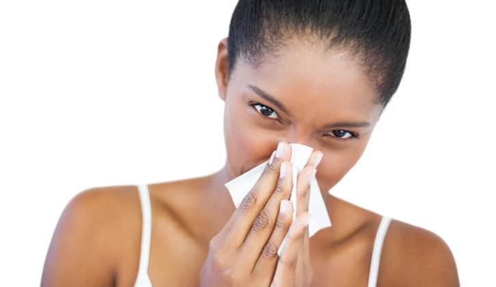 African American woman sneeze blowing nose