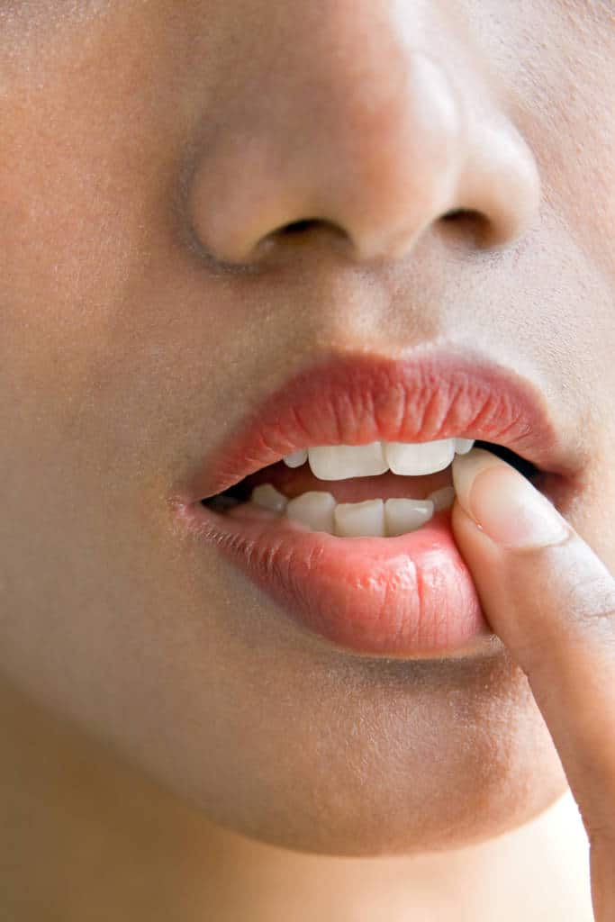 detail of finger in open mouth
