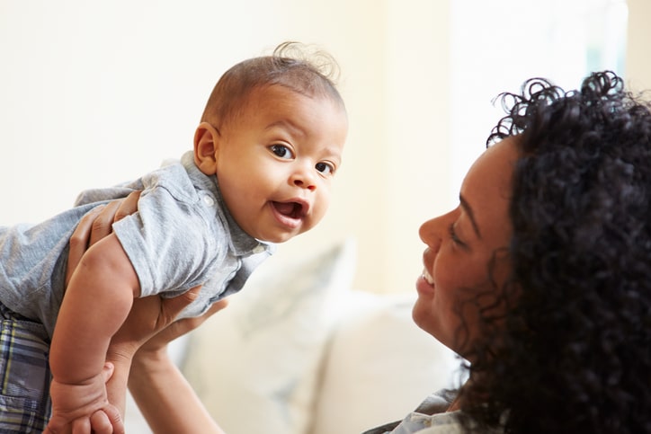 smiling mother with happy baby boy